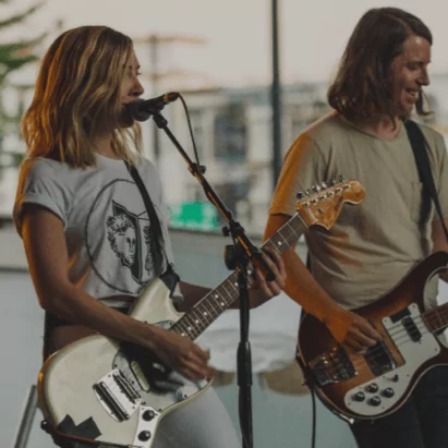 Lead singer and guitarist singing in front of microphone