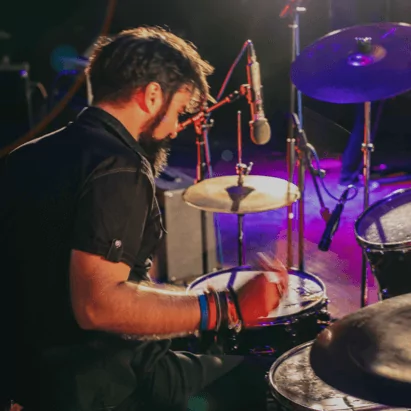 Drummer playing drums during concert